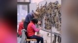 Volunteers And Refugees In Estonia Weave Camouflage Nets For The Ukrainian Army