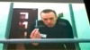 Aleksei Navalny appears on a monitor in a video link from prison during a court hearing in June.