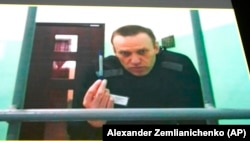 Aleksei Navalny appears on a monitor in a video link from prison during a court hearing in June.