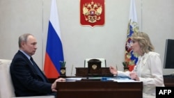 Russian President Vladimir Putin (left) meets with Maria Lvova-Belova, Russian children's rights commissioner, at the Novo-Ogaryovo state residence, outside Moscow, on February 16. 