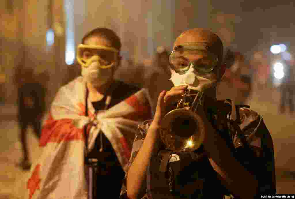  A protester plays a trumpet during protests in Tbilisi. &nbsp; 