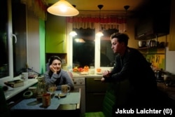 Svitlana and Oleksiy discuss their options in their kitchen in Avdiyivka in April 2021.