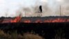 A stork flies over a burning field near the town of Snigurivka, Mykolayiv region, Ukraine, in July. 