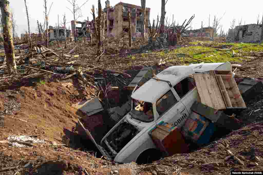 A car and ammunition boxes in a crater in Bakhmut on April 10. The eastern city has been under sustained Russian shelling since May 2022, while all-out infantry assaults have been ongoing since December. &nbsp;