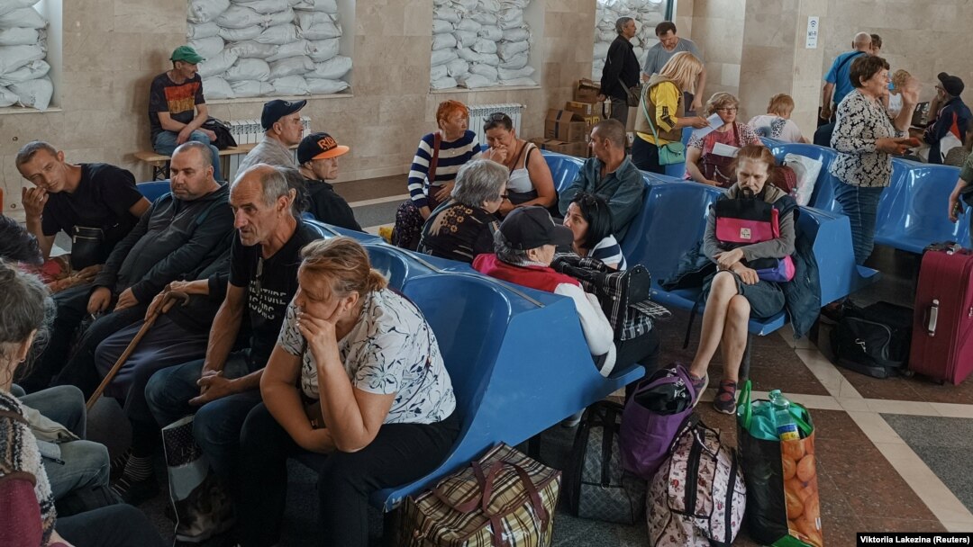 Local residents wait for an evacuation train at a railway station in Kherson on June 6.