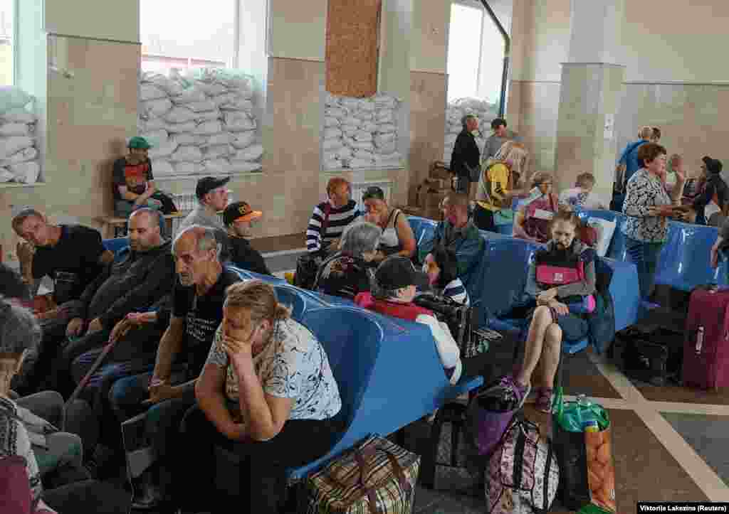 Residents wait for an evacuation train at the railway station in Kherson. Russia said Ukraine had carried out &quot;deliberate sabotage&quot; on the dam at Nova Kakhovka. It was not possible to independently verify what happened. &nbsp;