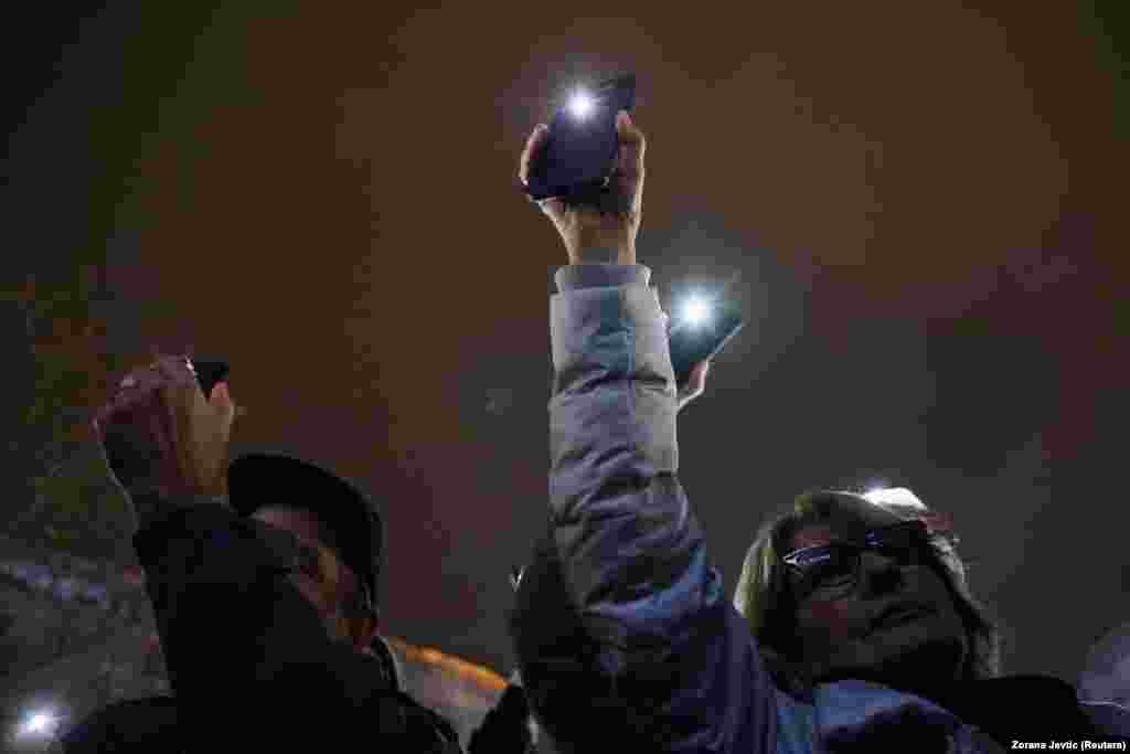 People used their mobile phones to shine a light during the rally. &nbsp;