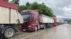 Trucks wait at the Merdare border crossing between Kosovo and Serbia on June 15 amid tightened border controls. 