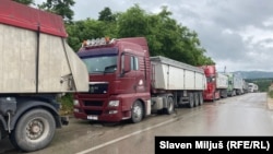 Trucks wait at the Merdare border crossing between Kosovo and Serbia on June 15 amid tightened border controls. 