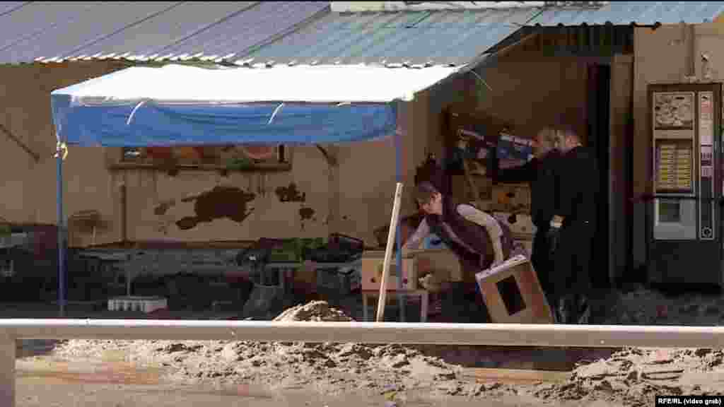 Another video grab shows residents removing mud.