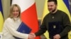 Ukrainian President Volodymyr Zelenskiy (right) and Italian Prime Minister Giorgia Meloni shake hands before a joint news briefing in Kyiv on February 21. 