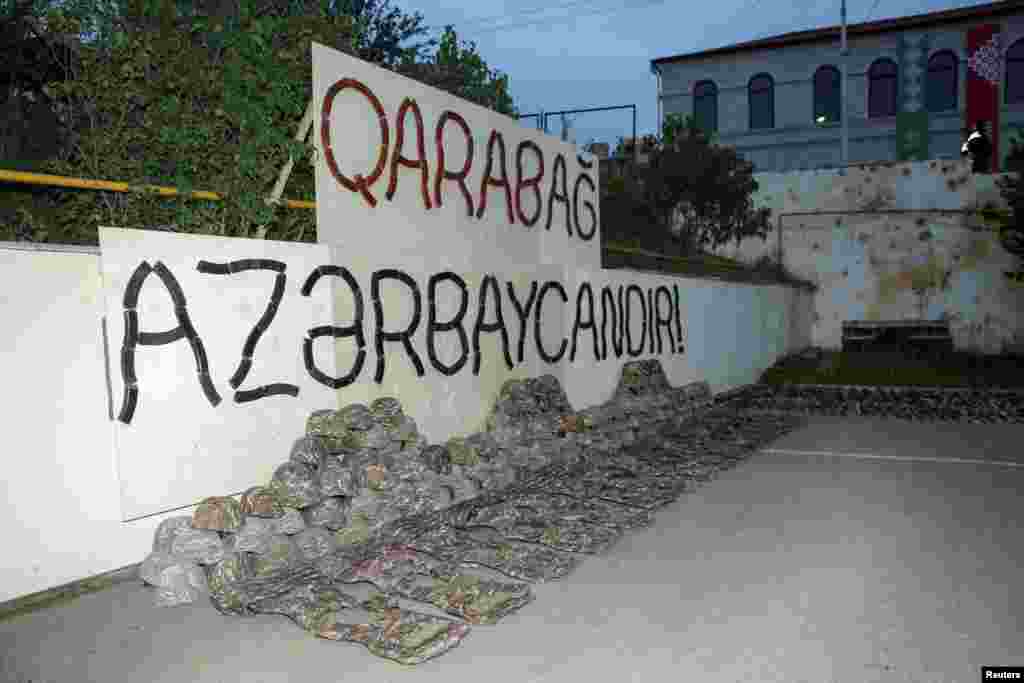 Uniforms of ethnic Armenian soldiers displayed under a sign made with automatic rifle magazines says &quot;Karabakh is Azerbaijan!&quot; in Susa, known as Shushi in Armenian. The military of the separatist region began to be disbanded after a September 20 agreement was reached between Azerbaijan and ethnic Armenian authorities.&nbsp;