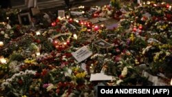 Flowers are seen placed around portraits of late Russian opposition leader Aleksei Navalny at a makeshift memorial in front of the Russian Embassy in Berlin on February 23 during a rally marking the eve of the second anniversary of Russia's invasion of Ukraine. 