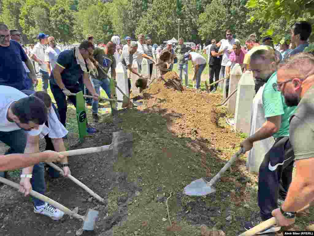 Men prepare the graves.