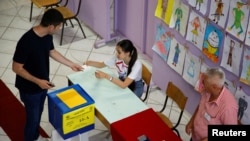 A man casts his ballot in snap parliamentary elections in the Montenegrin capital, Podgorica, on June 11. 