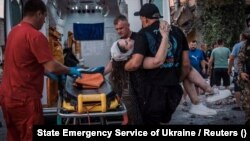 Rescuers work at the site where a building was destroyed during a Russian missile strike in Pokrovsk, in Ukraine's Donetsk region, on August 7.