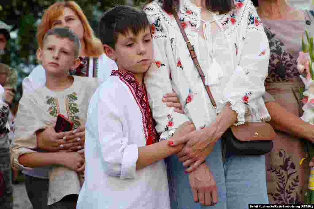 A boy dressed in a traditional Ukrainian embroidered shirt attends Babinskiy&#39;s memorial.