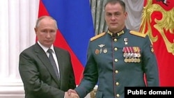 Russian President Vladimir Putin (left) after awarding Irek Magasumov the Hero of Russia medal.