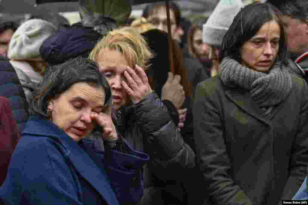 Mourners outside the university headquarters pay their respects in the rain. The gunman, who was a student at the Faculty of Arts, opened fire in the faculty building near Jan Palach Square, in an area near Prague&#39;s historic Old Town. &nbsp;