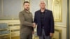 Ukrainian President Volodymyr Zelenskiy shakes hands with visiting former U.S. Vice President Mike Pence (right) in Kyiv on June 29.