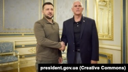 Ukrainian President Volodymyr Zelenskiy shakes hands with visiting former U.S. Vice President Mike Pence (right) in Kyiv on June 29.