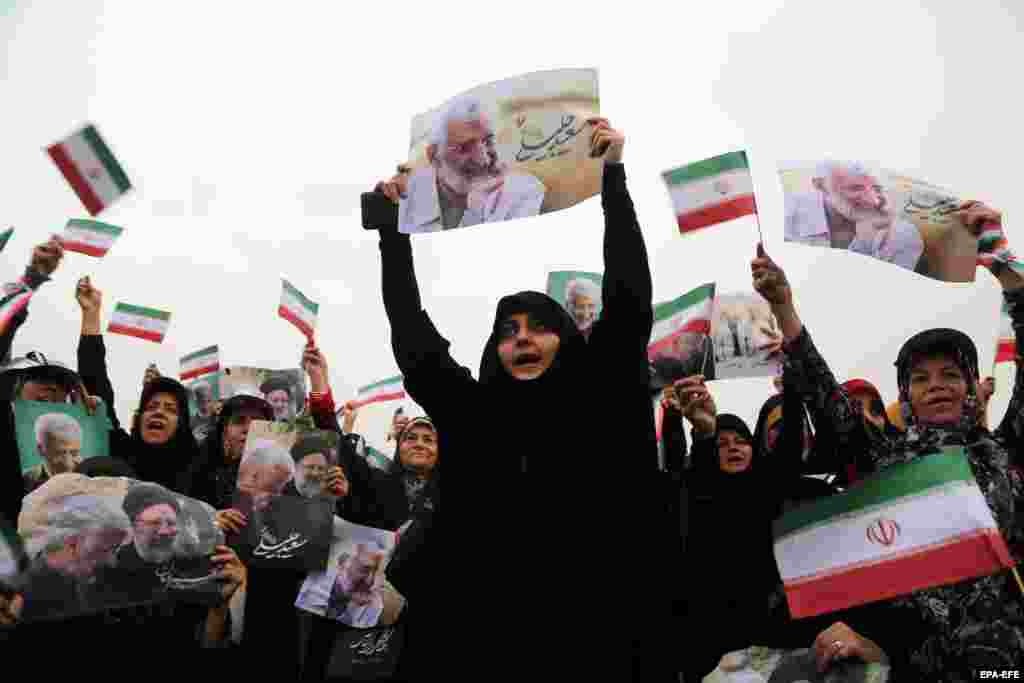 Supporters of Iranian presidential hard-line candidate Saeed Jalili cheer during an election campaign in Tehran ahead of a presidential election on June 28.