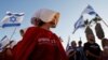 Egy, <em>A szolgálólány meséje</em> televíziós sorozat szereplőjének öltözött nő tüntet az izraeli igazságügyi reformok ellen az amerikai konzulátus közelében Tel-Avivban 2023. július 18-án