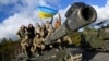 Ukrainian personnel pose with a flag on top of a Challenger 2 tank during training in southwestern Britain in February.