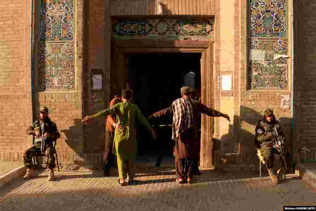 Afghan security personnel frisk devotees entering to offer Eid al-Adha prayers at the Jami mosque in Herat.&nbsp;