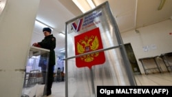 Un militar votează la alegerile prezidențiale din Rusia, în regiunea Leningrad, pe 15 martie 2024.