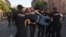 Armenian police officers detain a protester outside the government building in Yerevan on August 8. Tensions between Baku and Yerevan have escalated sharply in recent days as both sides accuse the other of cross-border gunfire and violating agreements.