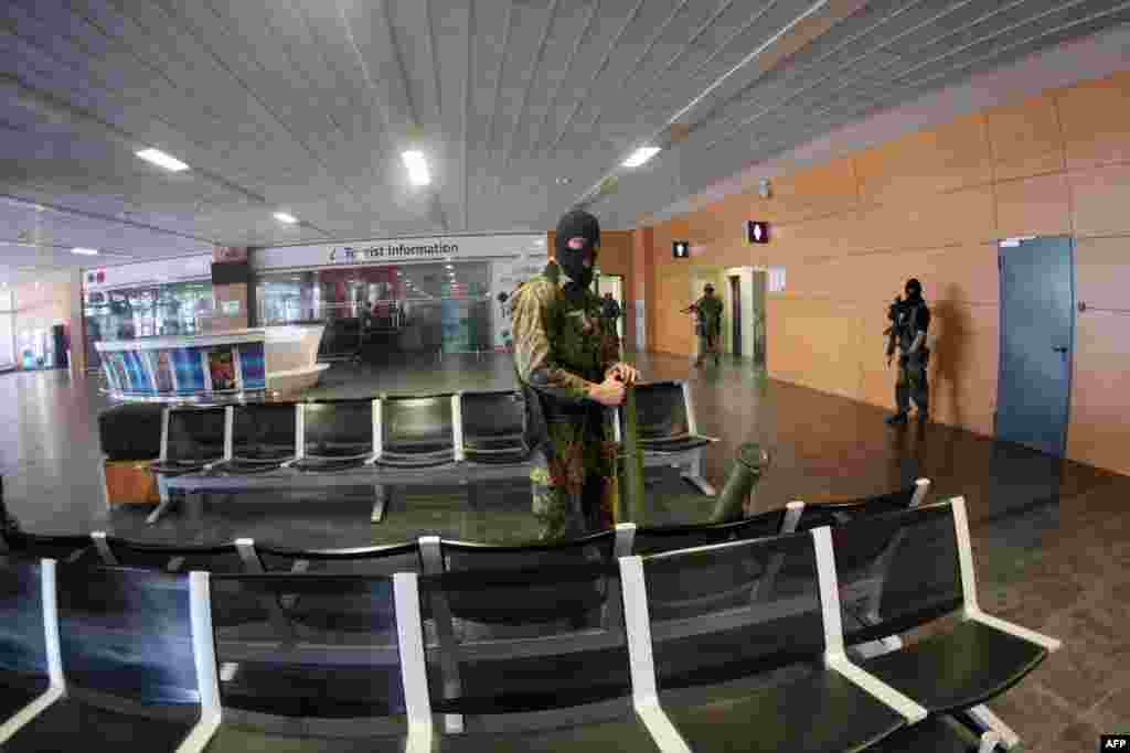 Russian-backed militants patrol inside the airport on May 26, 2014. Separatists seized the Donetsk facility immediately after a presidential election saw Petro Poroshenko voted into power on May 25, following the ousting of pro-Russian President Viktor Yanukovych.&nbsp; &nbsp;