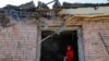 A woman looks out of her house, which was badly damaged by recent shelling in the town of Horlivka in eastern Ukraine. 