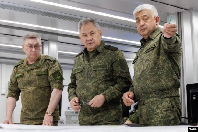 A photo released by the Russian Defense Ministry purported to show Defense Minister Sergei Shoigu (center) inspecting a military unit on June 26.