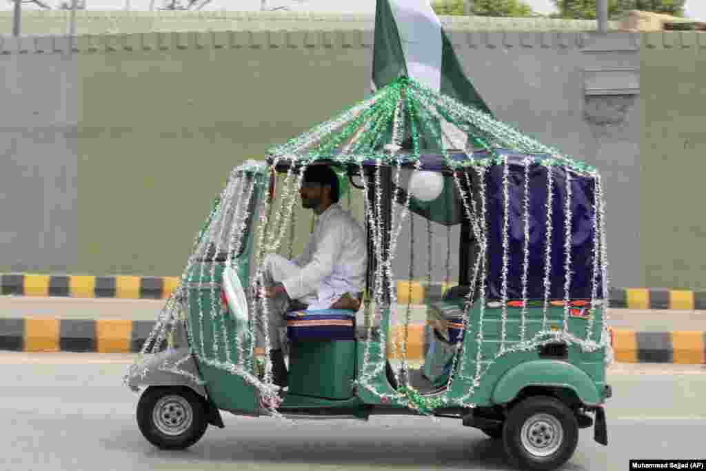 A driver in Peshawar decorates his rickshaw with the colors of Pakistan&#39;s national flag to celebrate the country&#39;s Independence Day on August 14.&nbsp;