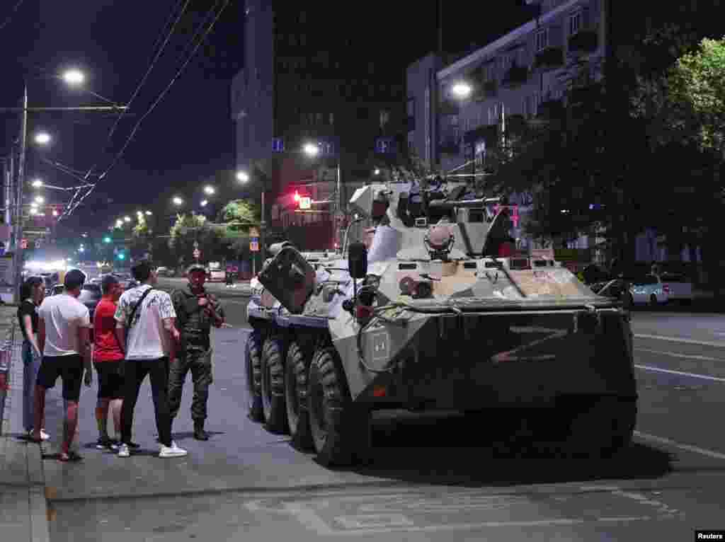 An image made before dawn on June 24 showing civilians in Rostov-on-Don gathered around an armored vehicle marked with the letter Z associated with Russia&#39;s invasion of Ukraine.&nbsp;
