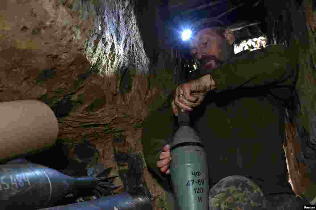 A mortar is prepared by a Ukrainian soldier in his dugout. In total, Ukrainian forces fought 37 close-quarter battles over the past 24 hours along the entire front line, the military said. The claims could not be independently verified.