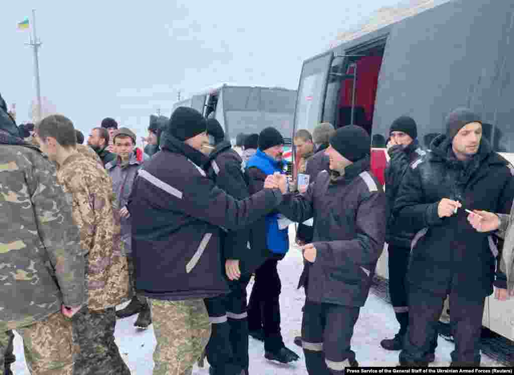 Newly released Ukrainian POWs celebrate on Ukrainian-held territory on February 4, 2023.