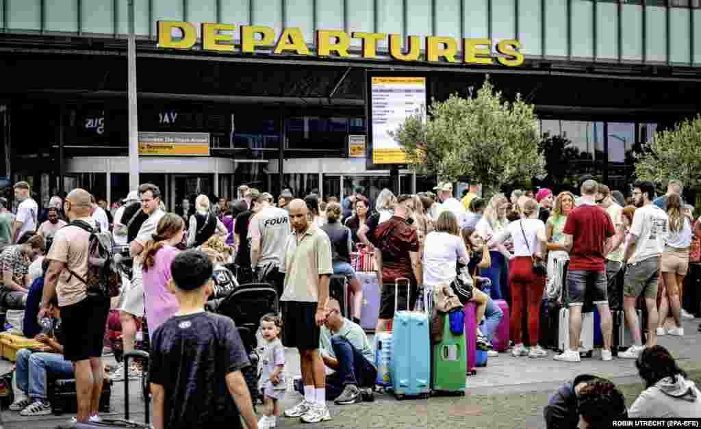 Passengers who were unable to check in at Rotterdam-The Hague Airport wait outside.