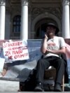 Belgrade -- LGBT+ young man is on a hunger strike due to police brutality in front of the Serbian Parliament, 15 April 2024