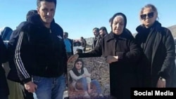 A family visits the grave of a protester killed in the unrest in the western city of Sanandaj on February 23.