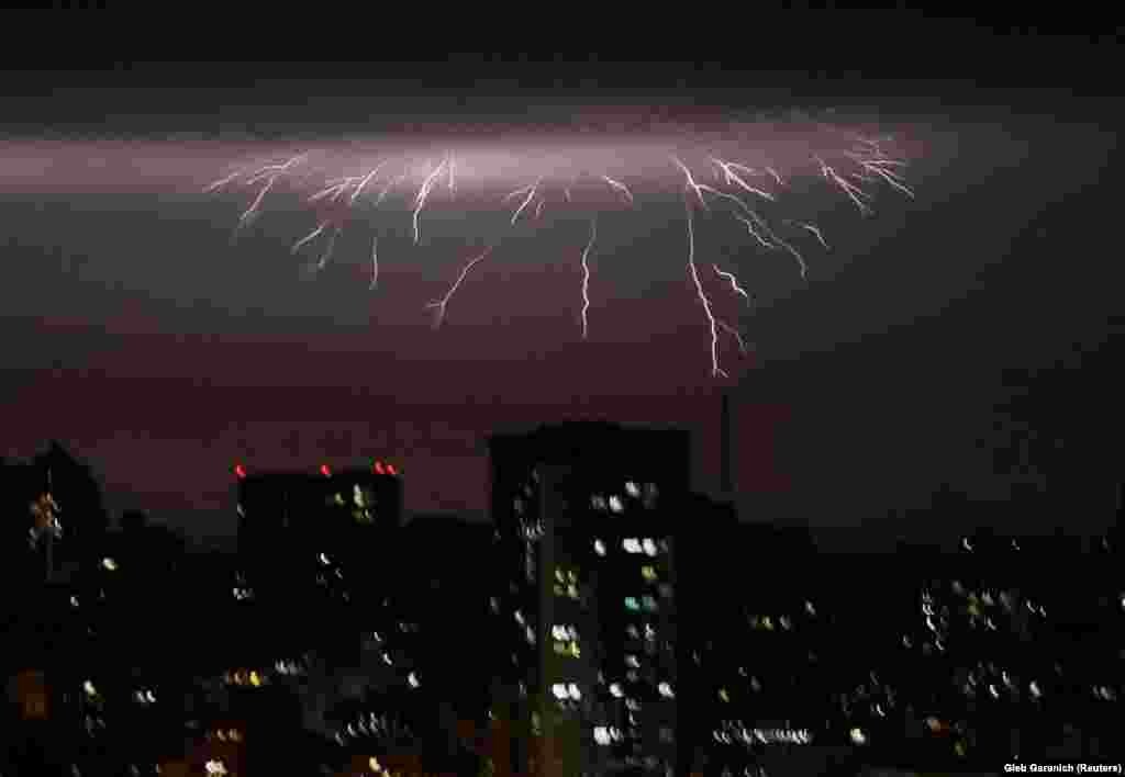 Lightning is seen over the city during a storm in Kyiv.