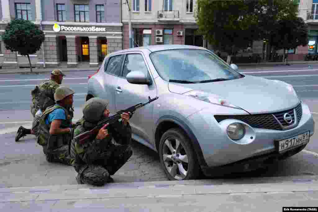 Men reportedly with the Wagner group take up positions behind a civilian car.&nbsp; Russia&rsquo;s Federal Security Service announced a criminal case against Prigozhin for &ldquo;incitement to armed rebellion&rdquo; after he vowed to lead a &ldquo;march of justice&rdquo; against top officials in Russia&rsquo;s Defense Ministry.