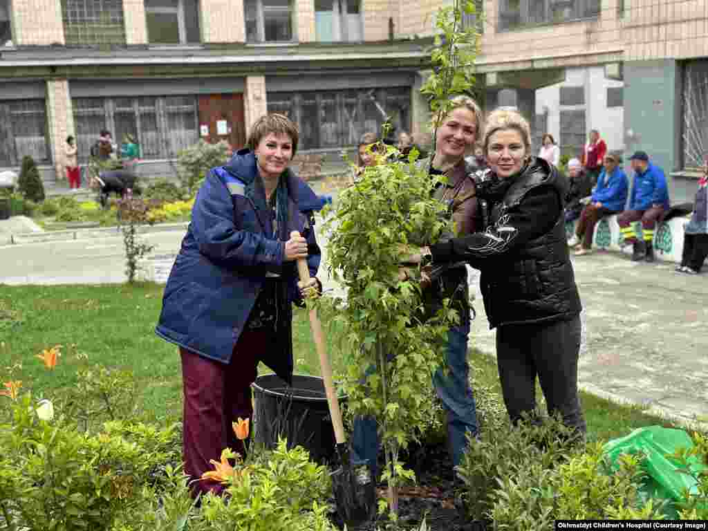 Women plant a garden in the Okhmatdyt hospital grounds in April 2024. Since the opening days of the 2022 full-scale Russian invasion, the Kyiv hospital and its staff have offered a safe space for children whose lives were upended by war.