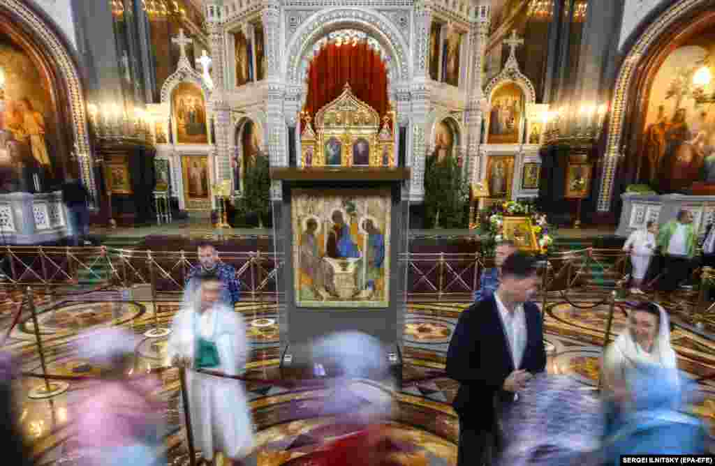 Russian Orthodox believers worship at the Trinity icon by Andrei Rublev during a church service in the Cathedral of Christ the Savior in Moscow.&nbsp;