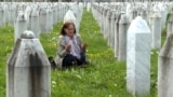 Bosnia-Herzegovina - Nura Begovic prays for her brother, Adil Suljic, at the memorial in Potocari for Srebrenica victims - screen grab