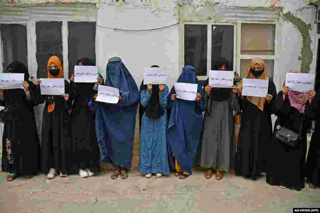 Burqa-clad women hold placards demanding their right to education in Mazar-i-Sharif in June. Women have been banned from attending university, and their job opportunities have been largely restricted to the health and education sectors.