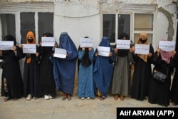 Afghan women hold placards demanding their right to education in the northern city of Mazar-e Sharif in June.
