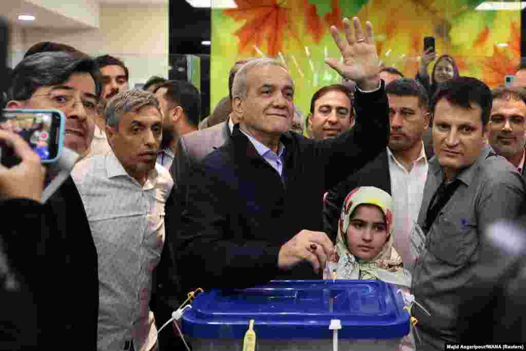 Presidential candidate Masud Pezeshkian votes at a polling station. The elections come at a time of growing frustration among many over a lack of freedoms, declining living standards, and a faltering economy.