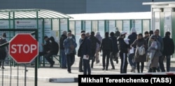 Foreign citizens gather outside Moscow's multifunctional migration center.